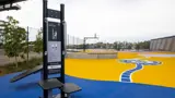 Exercise equipment and basketball court at Bank Street Park